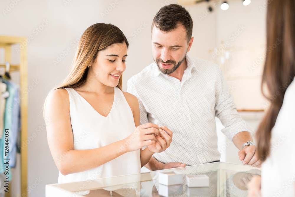 Cute girl choosing a ring with her boyfriend