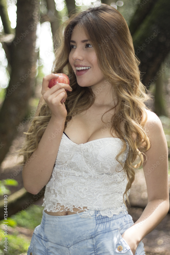 Smiling Young woman eating an apple Smiling Young woman eating an apple