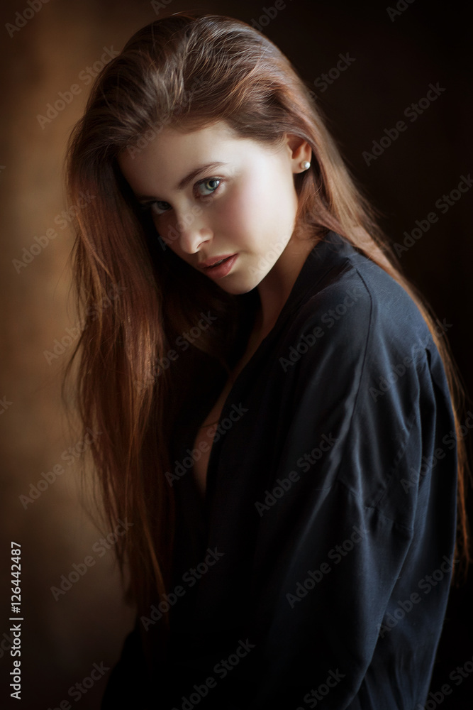 Fototapeta premium Beautiful female brunette model in shirt
