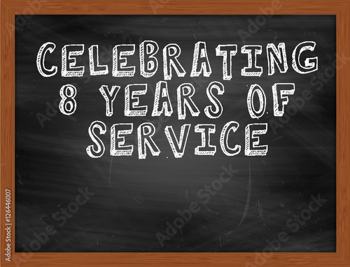 CELEBRATING 8 YEARS OF SERVICE handwritten text on black chalkbo photo