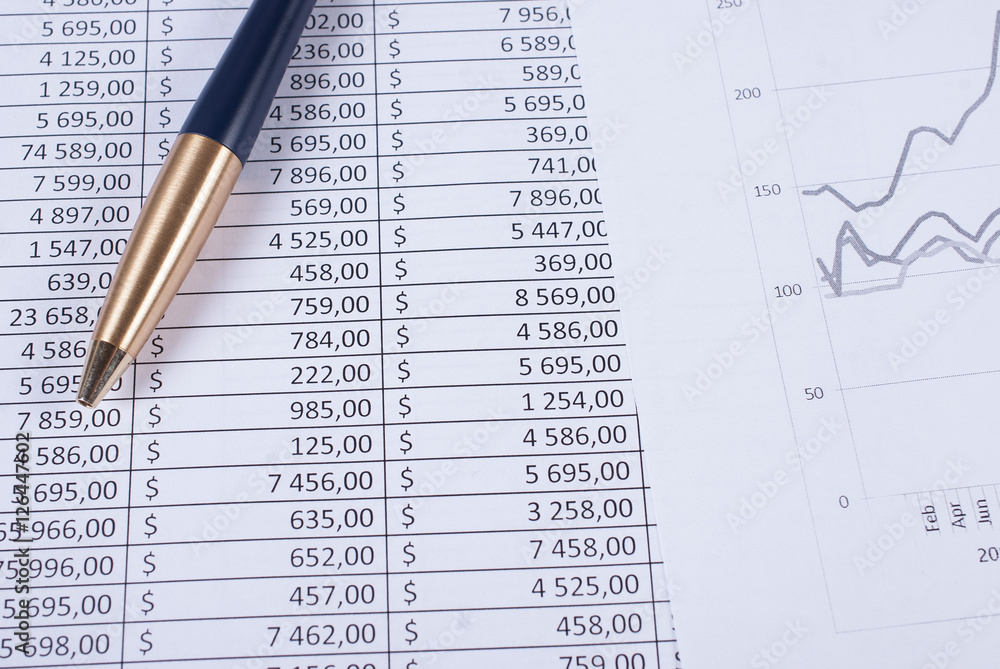 Pen lying on the financial statements. Business concept Pen lying on the financial statements. Business concept
