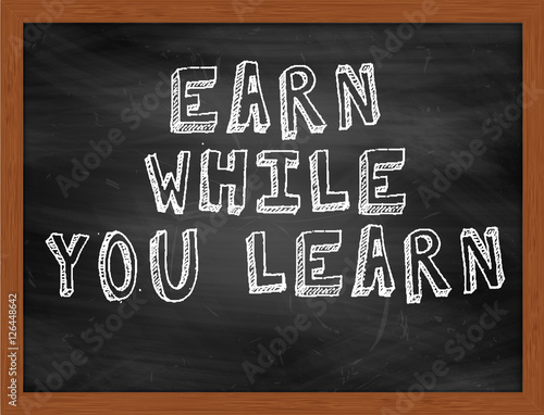 EARN WHILE YOU LEARN handwritten text on black chalkboard