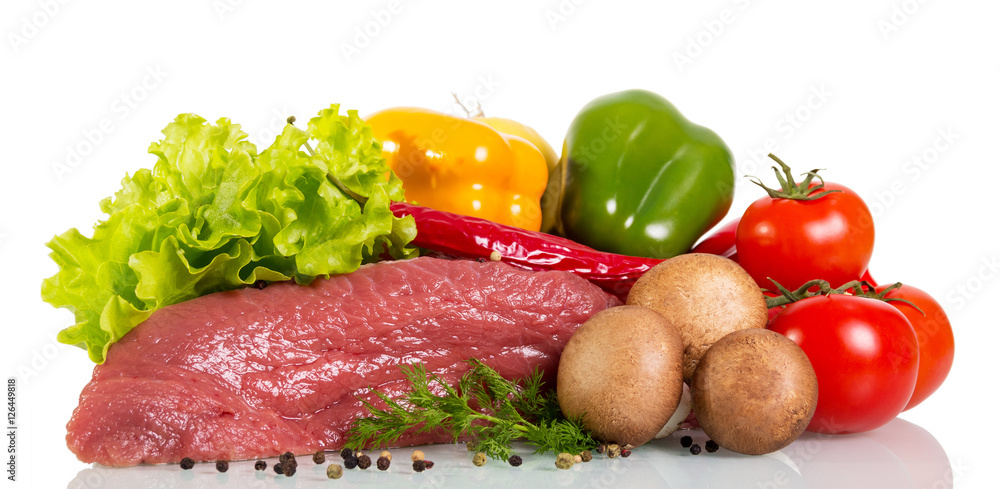Piece of raw beef, vegetables, herbs and spices isolated.