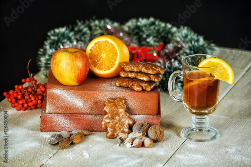 Mulled wine for Christmas with orange apples on dark background