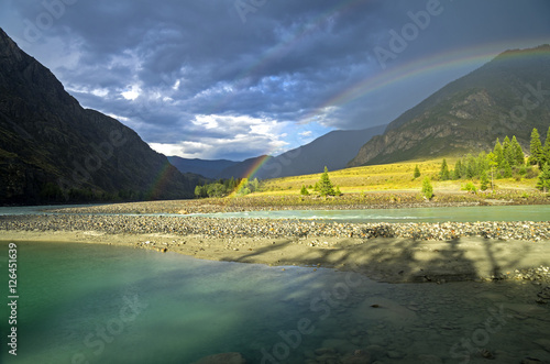 Rainbow over the river. Altai Mountains  Russia.