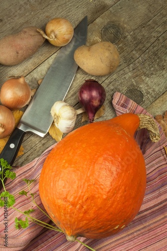Ripe pumpkins Hokkaido. Autumn vegetables on the kitchen table. Advertising for sale. Preparing traditional pumpkin soup.  