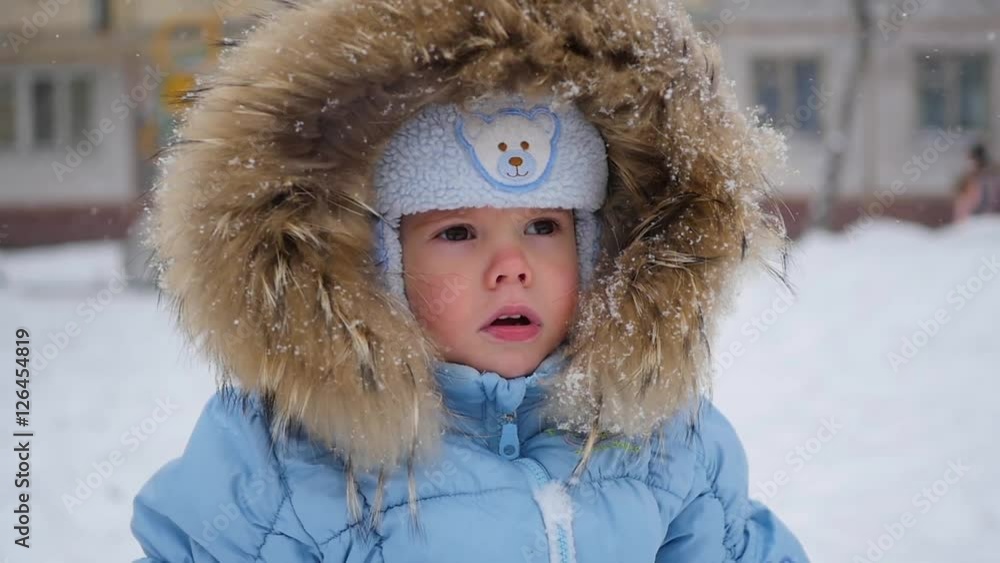 a small happy child watch snowflakes in the park a small happy child watch snowflakes in the park