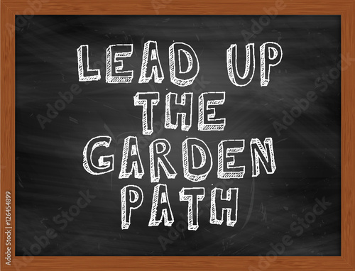 LEAD UP THE GARDEN PATH handwritten text on black chalkboard