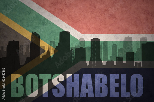 abstract silhouette of the city with text Botshabelo at the vintage south africa flag photo