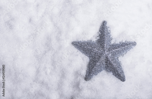 Silver star placed in snow