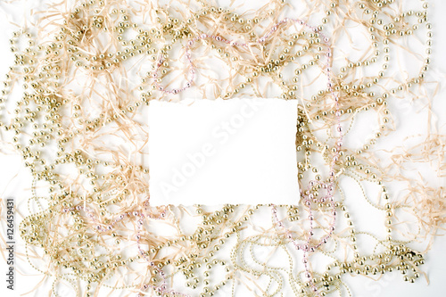 empty paper blank and christmas tinsel decoration. flat lay, top view