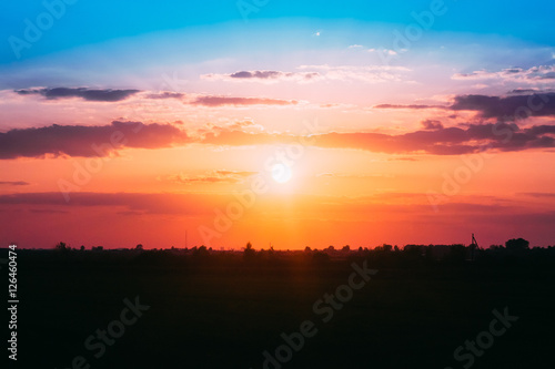 Scenic Red And Orange Sunset On Dramatic Cloudy Sky Over Dark Fi