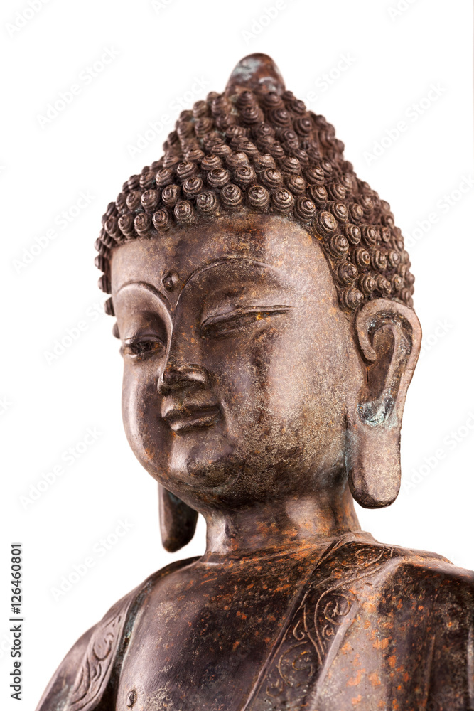 A head of Buddha Shakyamuni's. The old statue made of metal isolated on a white background.