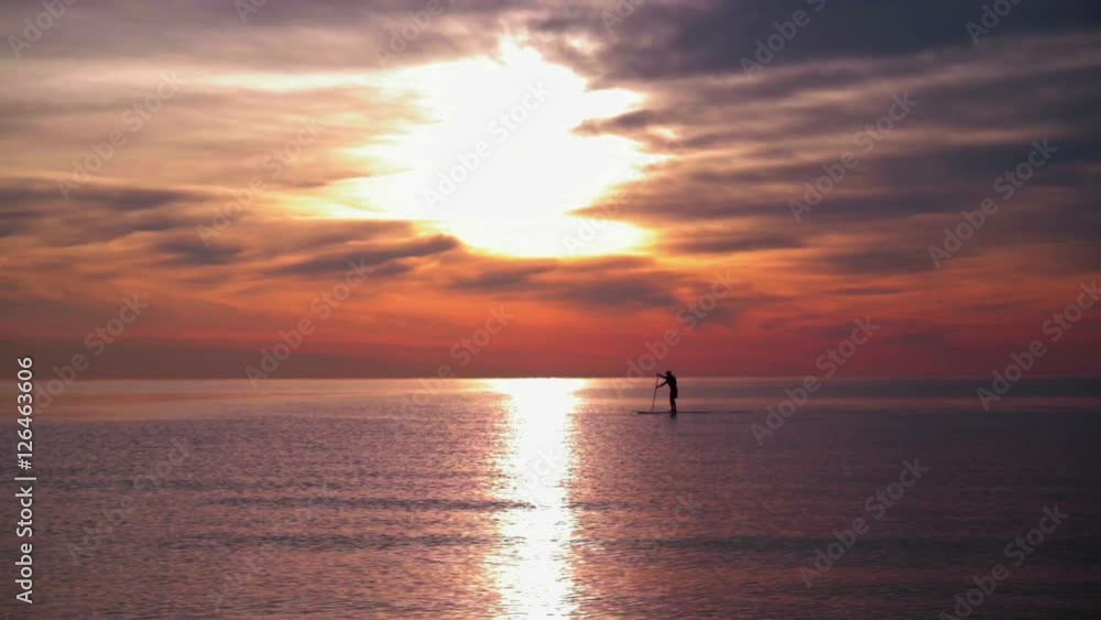 Sunset sea. Man rowing on surfboard at sunset. Sea sunset with calm water. Tranquil water of sunset sea. Calm sea waves at sea sunset. Surfing at sunset sea. Sun reflection at sea Sunset sea. Man rowing on surfboard at sunset. Sea sunset with calm water. Tranquil water of sunset sea. Calm sea waves at sea sunset. Surfing at sunset sea. Sun reflection at sea