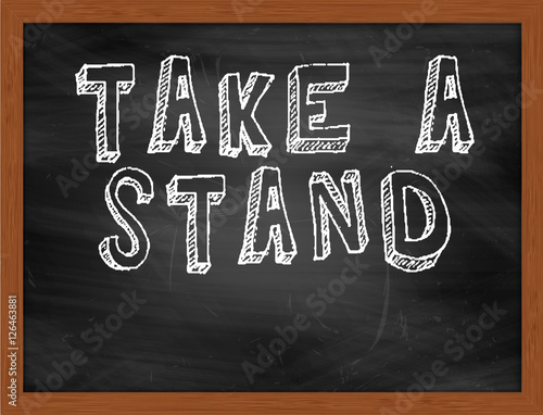 TAKE A STAND handwritten text on black chalkboard