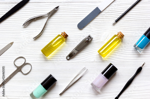 nail polish  cuticle oil and manicure set on wooden background
