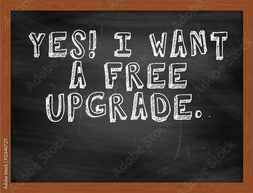 YES I WANT A FREE UPGRADE handwritten text on black chalkboard