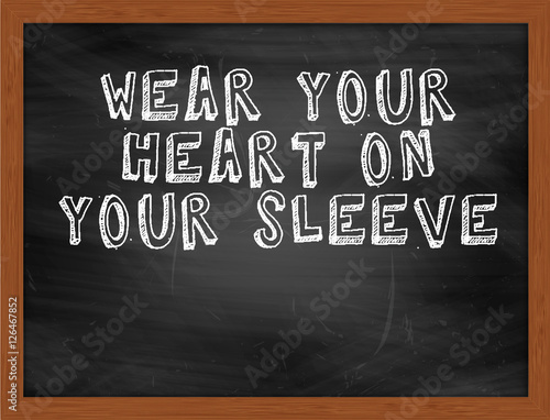 WEAR YOUR HEART ON YOUR SLEEVE handwritten text on black chalkbo