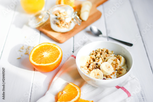 healthy breakfast bowl of yogurt with granola and banana