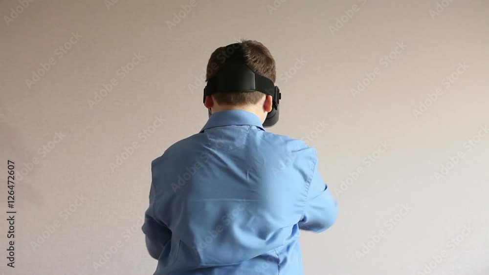 Teenage boy in glasses virtual reality room. Teenage boy in glasses virtual reality room.
