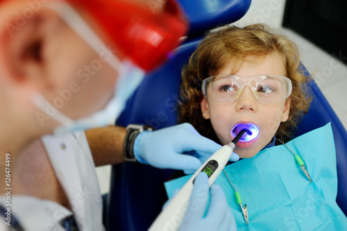 pediatric dentist man makes dental fillings baby boy