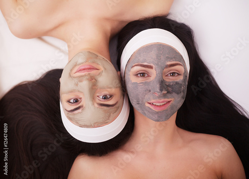 Use of a face mask to the face two young women in a beauty salon