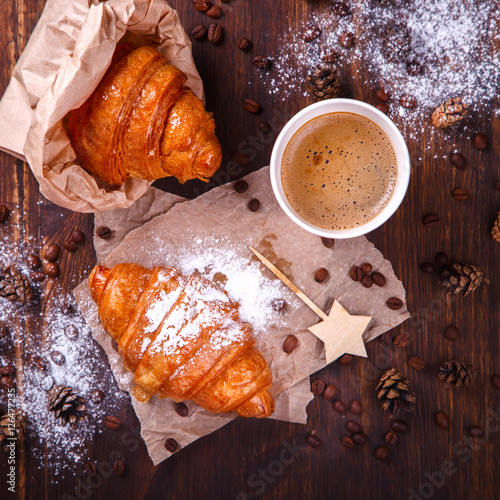  Christmas or New Year pastries,Croissant with a warming drink,coffee.Winter Holidays Concept.Holiday Decorations. top view.Vintage style. selective focus.
