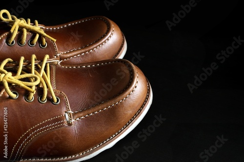 Handmade leather shoes on black background