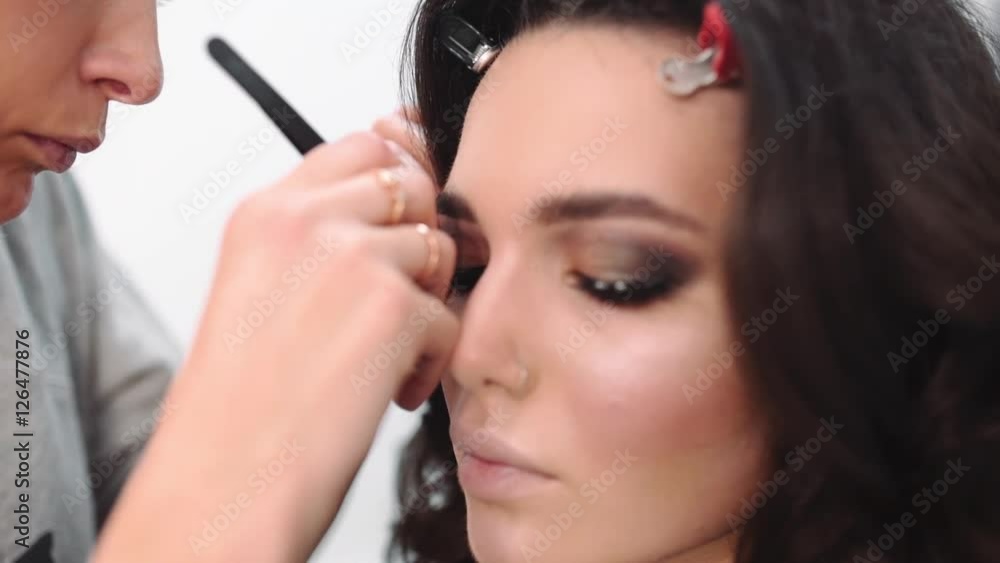 Lash maker increases eyelashes, make up artist making long lashes, woman in beauty studio makes evening make up, beautiful caucasian girl makes a make up Lash maker increases eyelashes, make up artist making long lashes, woman in beauty studio makes evening make up, beautiful caucasian girl makes a make up