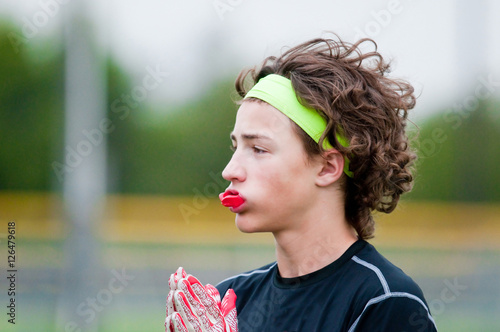 Youth football boy with long hair