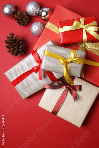 Presents with christmas decoration on red background © t4nkyong