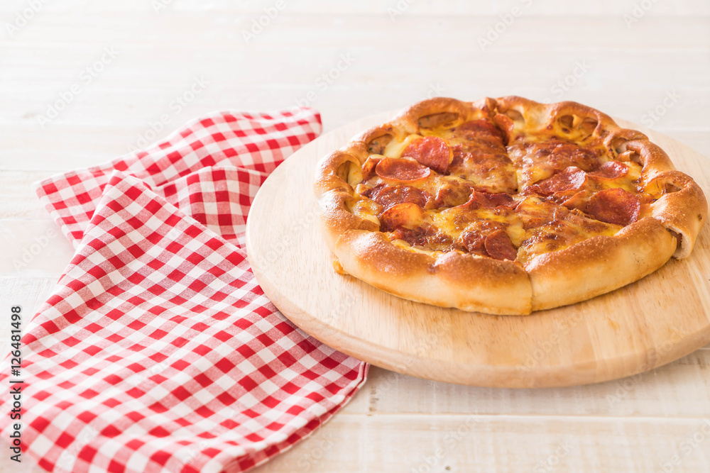 Homemade Pepperoni Pizza on wood plate Homemade Pepperoni Pizza on wood plate
