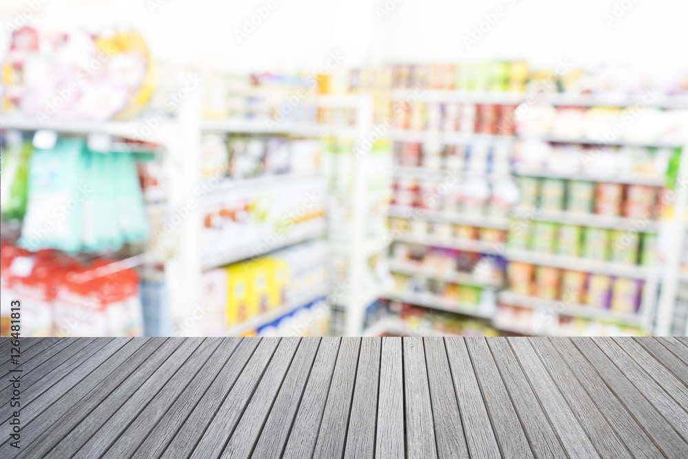 Empty top of wooden table and supermarket blur background Empty top of wooden table and supermarket blur background