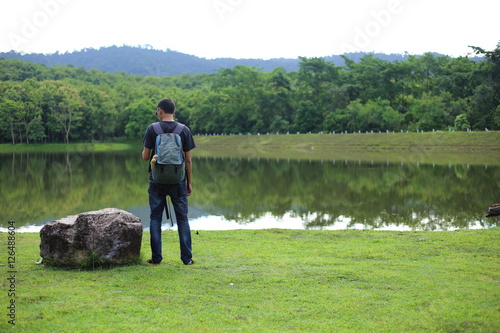 Man and reflection on lake at Chet Khot waterfall ,Thailand