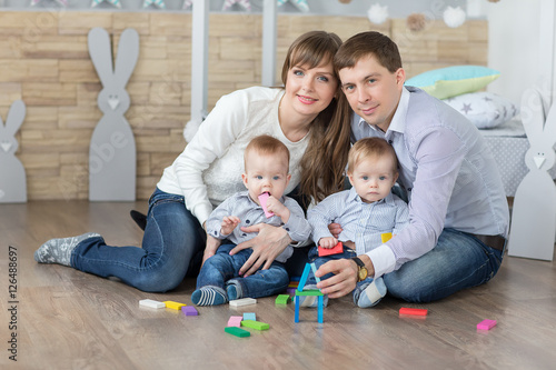 Happy young family are built of wooden planks house