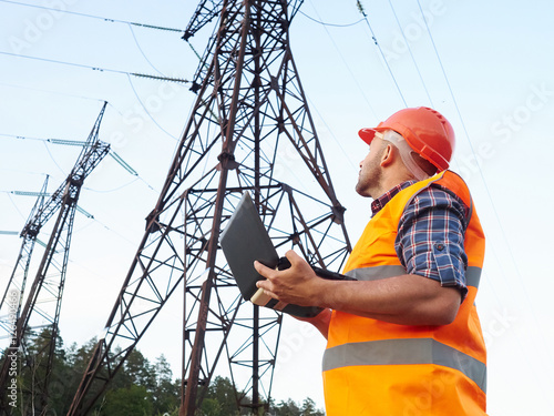 Electrical engineer working. Talking on the phone and working wo
