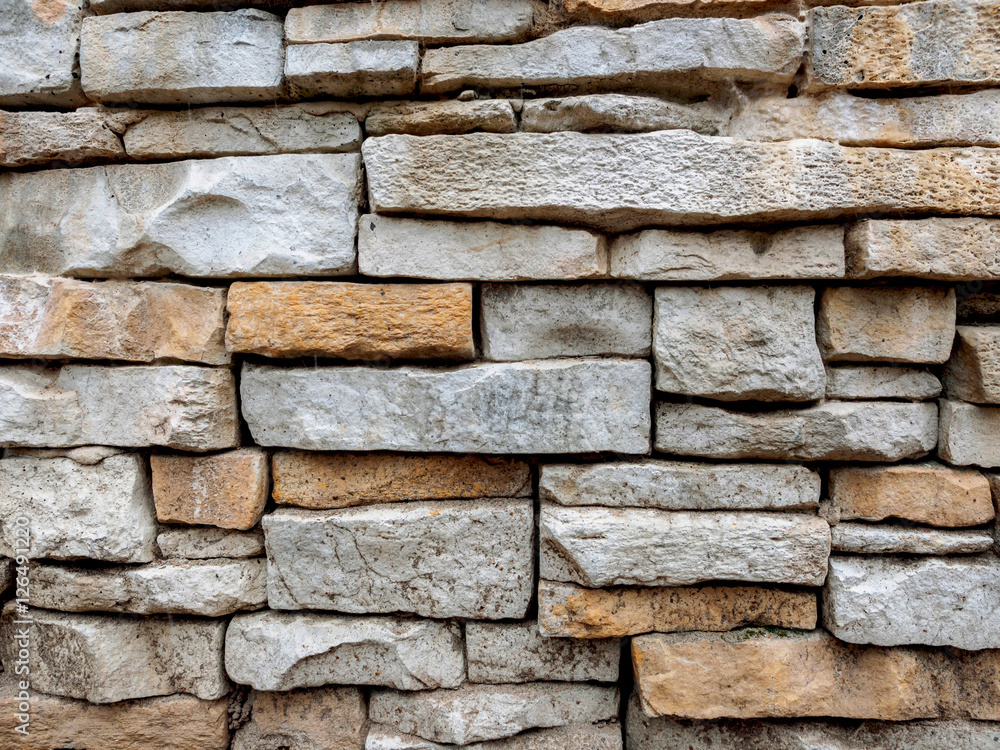 Texture of a stone laying from the gray and yellow stone put in any order. Texture of a stone laying from the gray and yellow stone put in any order.