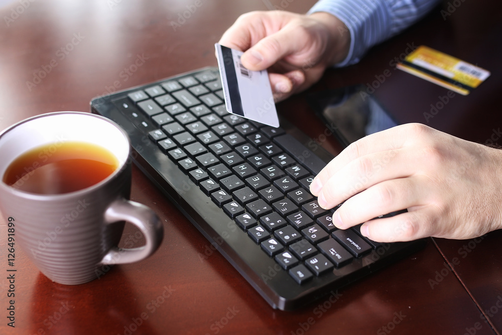 man pays for online purchases with a credit card man pays for online purchases with a credit card