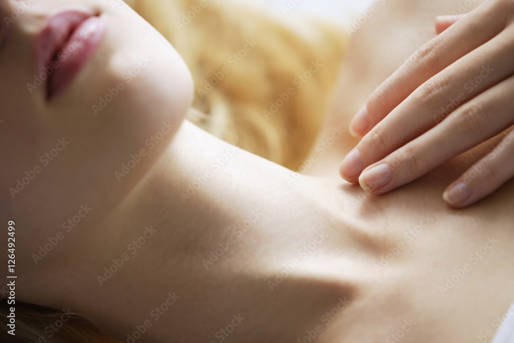 close up of young woman's mouth, neck and hand