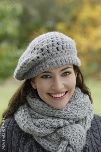 Young woman in knit hat and scarf
