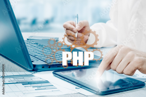 technology and internet concept - businessman holds the php button on virtual screens