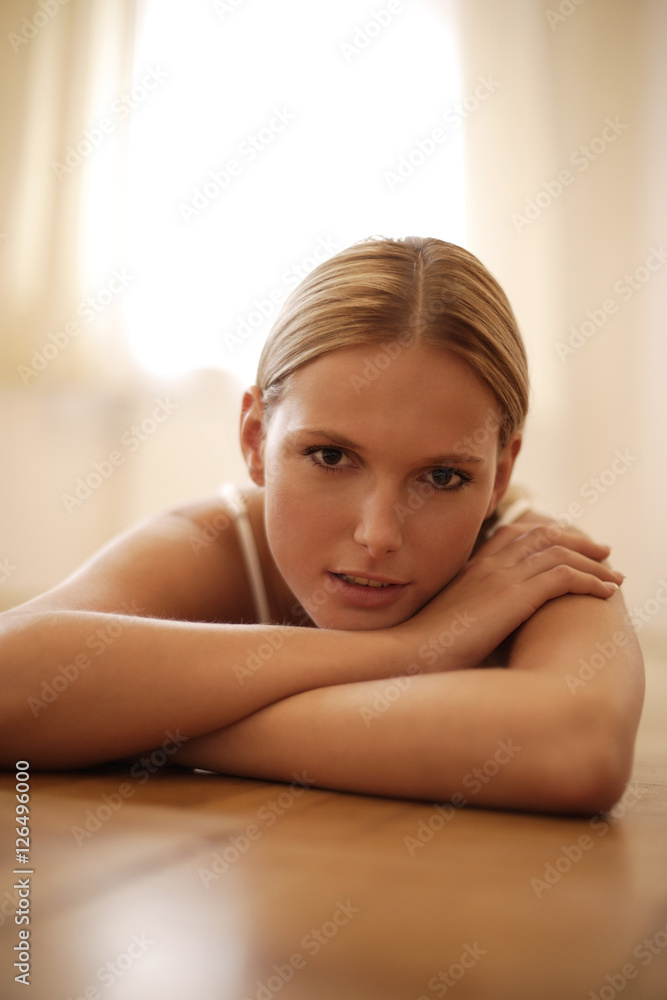 Portrait of young woman resting chin on arms Portrait of young woman resting chin on arms