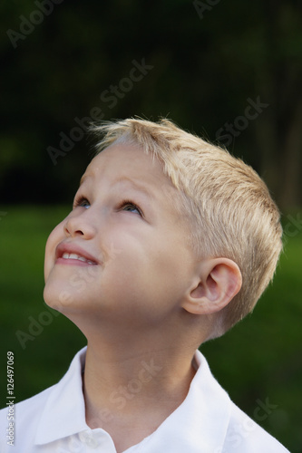 Profile of young boy looking up