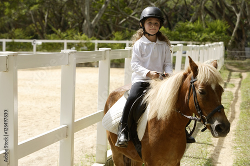young girl riding horse