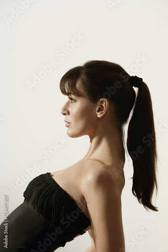 Profile of woman in black cocktail dress