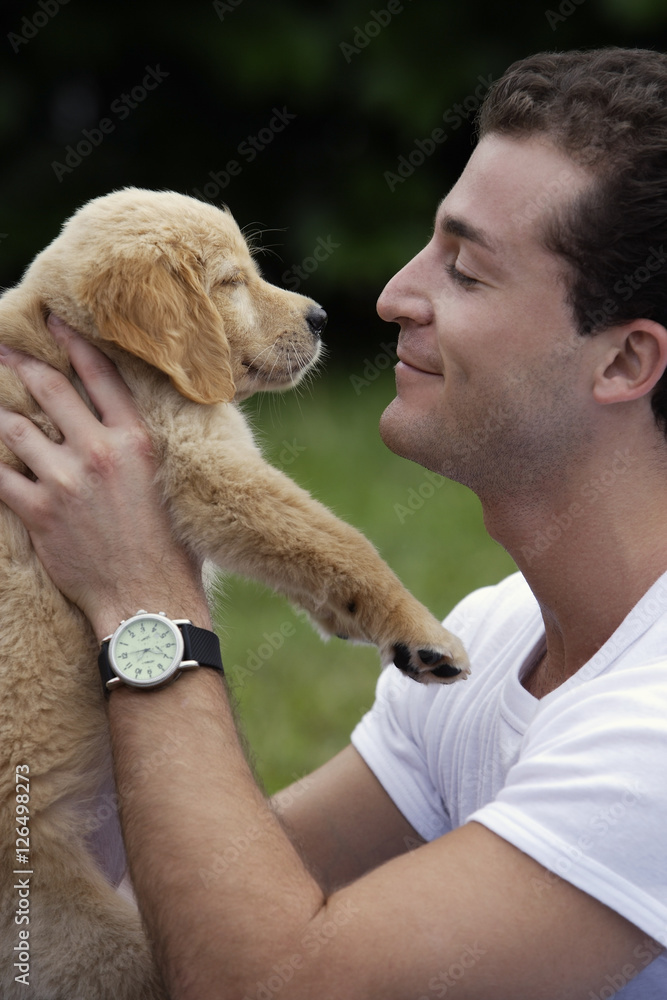 man at park with puppy man at park with puppy