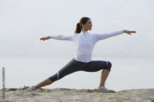 woman stretching on beach