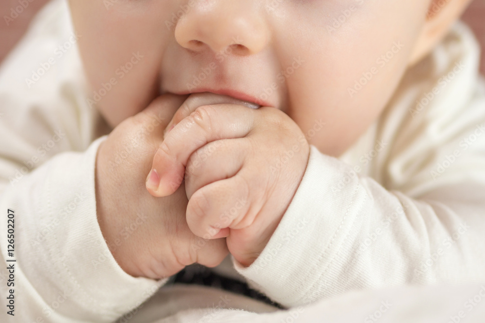 adorable happy baby biting his hands adorable happy baby biting his hands