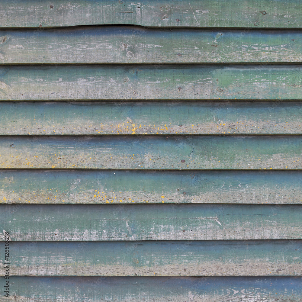 square part of shed wall consisting of old wooden planks with fa square part of shed wall consisting of old wooden planks with fa
