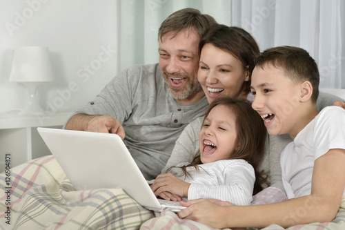 Family sitting with laptop